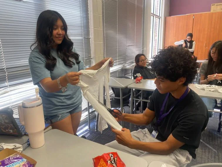 Students making toy donations from t-shirts